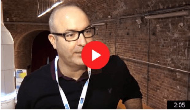 Freddy Friedman in a video interview setting with conference lanyard
