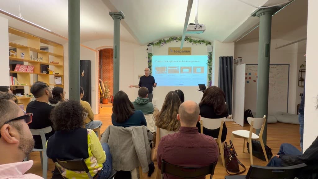 Freddy Friedman presenting in front of an audience with a slide on AI tools for engineers and non-engineers
